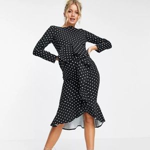 Polka dot maternity dress with ruffle and playful cut.